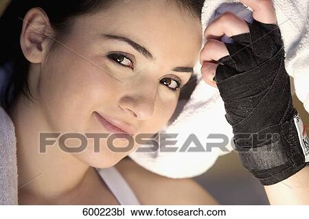Stock Image - headshot of young female boxer. Fotosearch