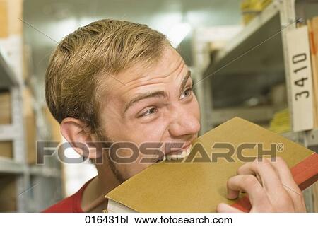 headshot of young male student biting into textbook View Large Photo Image Stock Image - headshot of young male student biting into textbook. Fotosearch
