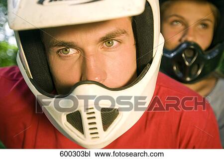 headshot of young man and girlfriend wearing helmet for motorsports View Large Photo Image Stock Image - headshot of young man and girlfriend wearing helmet for motorsports. Fotosearch