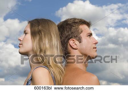 headshot of young woman and young man standing back to back View Large Photo Image Stock Image - headshot of young woman and young man standing back to back. Fotosearch