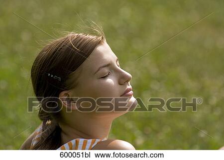 headshot of young woman enjoying the summer sun View Large Photo Image Stock Image - headshot of young woman enjoying the summer sun. Fotosearch