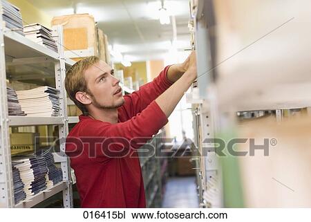 male student looking for book in school library View Large Photo Image Stock Image - male student looking for book in school library. Fotosearch