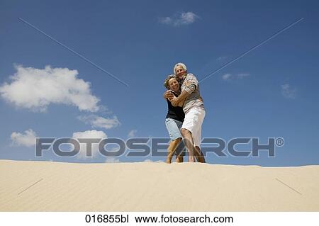 mature couple embracing on beach View Large Photo Image Stock Image - mature couple embracing on beach. Fotosearch