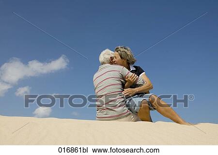 mature couple embracing on beach View Large Photo Image Stock Image - mature couple embracing on beach. Fotosearch
