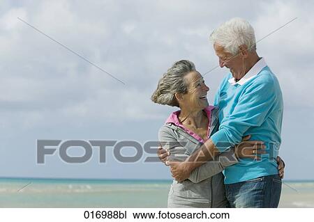 mature couple embracing on beach View Large Photo Image Stock Image - mature couple embracing on beach. Fotosearch