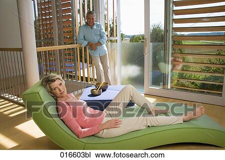 mature couple in living at home woman lying on chair View Large Photo Image Stock Image - mature couple in living at home woman lying on chair. Fotosearch