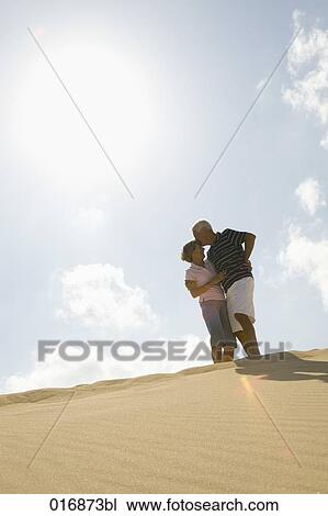 mature couple kissing on beach View Large Photo Image Stock Image - mature couple kissing on beach. Fotosearch