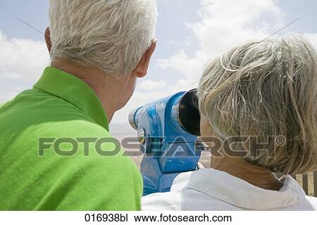 mature couple looking through binocular View Large Photo Image Stock Image - mature couple looking through binocular. Fotosearch
