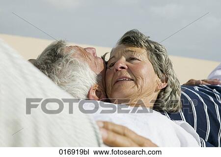 mature couple lying cheek to cheek View Large Photo Image Stock Image - mature couple lying cheek to cheek. Fotosearch