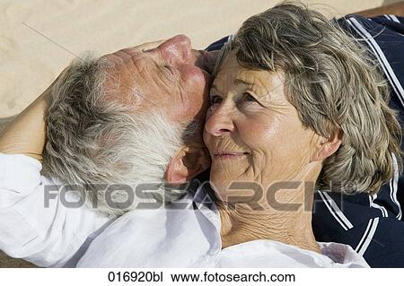 mature couple lying cheek to cheek View Large Photo Image Stock Image - mature couple lying cheek to cheek. Fotosearch