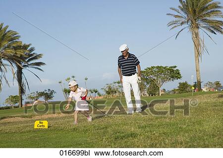 mature golf player and grandchild on golf course View Large Photo Image Stock Image - mature golf player and grandchild on golf course. Fotosearch