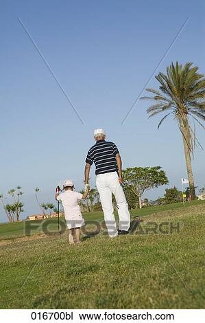 mature golf player and grandchild on golf course View Large Photo Image Stock Image - mature golf player and grandchild on golf course. Fotosearch