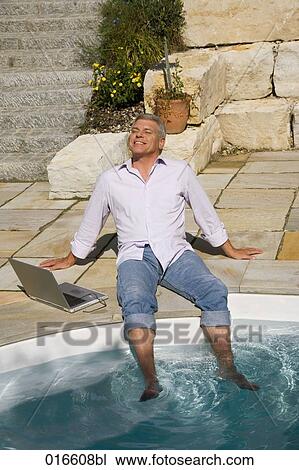 mature man enjoying the sun near swimming pool View Large Photo Image Stock Image - mature man enjoying the sun near swimming pool. Fotosearch