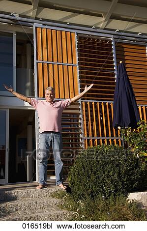 mature man in front of his home enjoying the first rays of sun View Large Photo Image Stock Image - mature man in front of his home enjoying the first rays of sun. Fotosearch