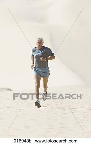 mature man running on sandy beach View Large Photo Image Stock Image - mature man running on sandy beach. Fotosearch
