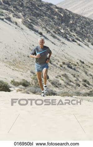 mature man running on sandy beach View Large Photo Image Stock Image - mature man running on sandy beach. Fotosearch
