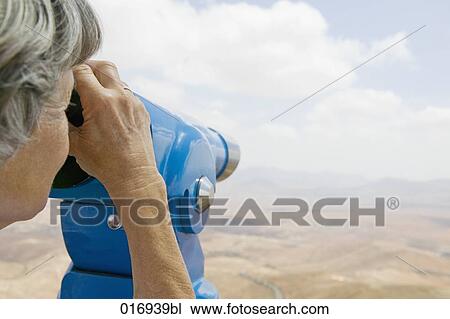mature woman looking through binocular View Large Photo Image Stock Image - mature woman looking through binocular. Fotosearch