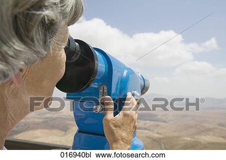 mature woman looking through binocular View Large Photo Image Stock Image - mature woman looking through binocular. Fotosearch