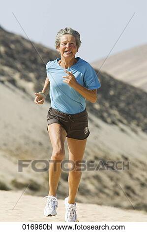 mature woman running on sandy beach View Large Photo Image Stock Image - mature woman running on sandy beach. Fotosearch