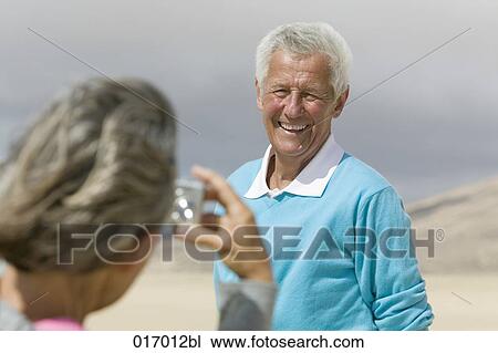 mature woman taking photograph of husband with digital camera View Large Photo Image Stock Image - mature woman taking photograph of husband with digital camera. Fotosearch