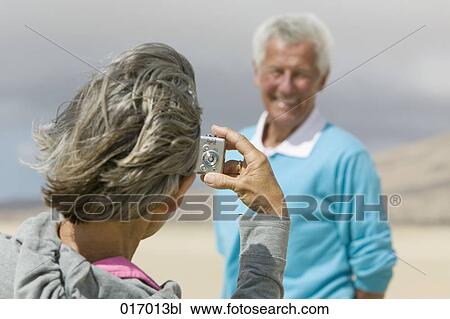 mature woman taking photograph of husband with digital camera View Large Photo Image Stock Image - mature woman taking photograph of husband with digital camera. Fotosearch