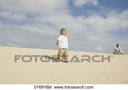 mother watching her young son walking on beach View Large Photo Image Stock Image - mother watching her young son walking on beach. Fotosearch