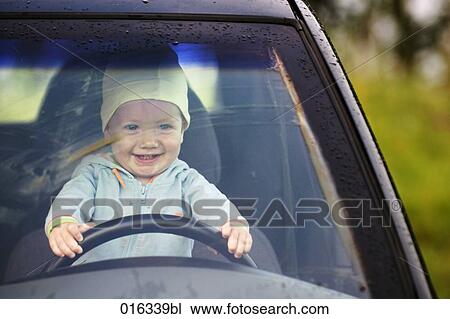 portrait of baby sitting behind steering wheel of car View Large Photo Image Stock Image - portrait of baby sitting behind steering wheel of car. Fotosearch