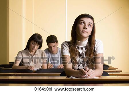 Stock Image - portrait of female student day-dreaming during school seminar. Fotosearch