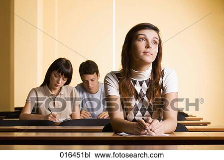Stock Image - portrait of female student day-dreaming during school seminar. Fotosearch