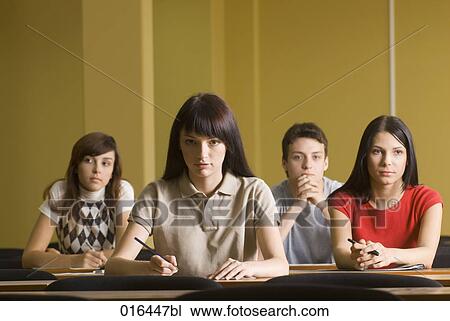 Stock Image - portrait of four students sitting in school seminar. Fotosearch