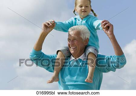 portrait of grandfather carrying young girl piggyback View Large Photo Image Stock Image - portrait of grandfather carrying young girl piggyback. Fotosearch