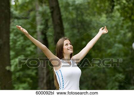portrait of happy young woman in park View Large Photo Image Stock Image - portrait of happy young woman in park. Fotosearch