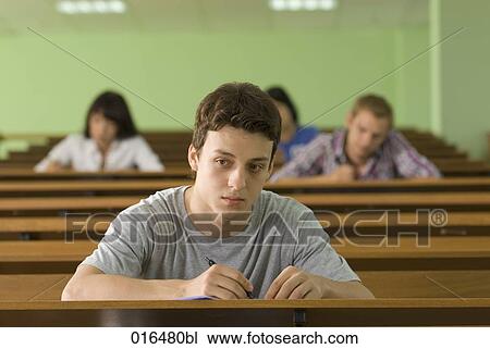 portrait of male student in lecture hall looking pensive View Large Photo Image Stock Image - portrait of male student in lecture hall looking pensive. Fotosearch