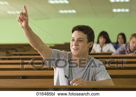 portrait of male student in lecture hall raising finger to answer question View Large Photo Image Stock Image - portrait of male student in lecture hall raising finger to answer question. Fotosearch