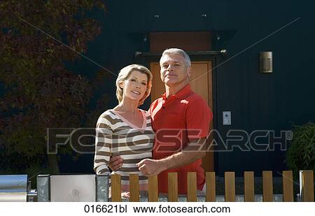 portrait of mature couple standing at garden fence of their home View Large Photo Image Stock Image - portrait of mature couple standing at garden fence of their home. Fotosearch