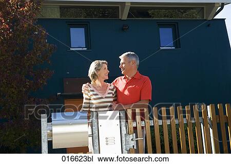 portrait of mature couple standing at garden fence of their home View Large Photo Image Stock Image - portrait of mature couple standing at garden fence of their home. Fotosearch