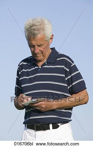 portrait of mature golf player making note on scorecard View Large Photo Image Stock Image - portrait of mature golf player making note on scorecard. Fotosearch