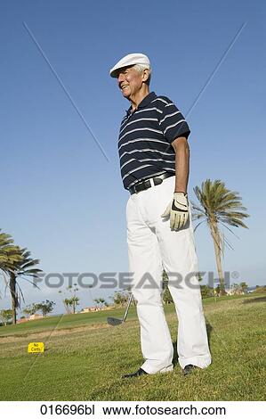 Stock Image - portrait of mature golf player wearing flat cap. Fotosearch