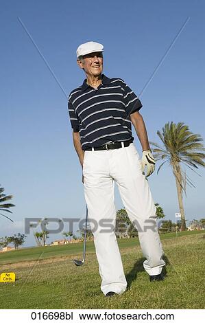Stock Image - portrait of mature golf player wearing flat cap. Fotosearch