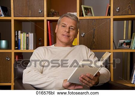portrait of mature man reading a book View Large Photo Image Stock Image - portrait of mature man reading a book. Fotosearch