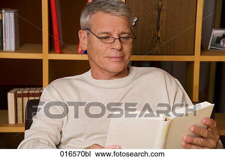 portrait of mature man with spectacles reading a book View Large Photo Image Stock Image - portrait of mature man with spectacles reading a book. Fotosearch
