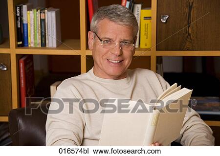 portrait of mature man with spectacles reading a book View Large Photo Image Stock Image - portrait of mature man with spectacles reading a book. Fotosearch