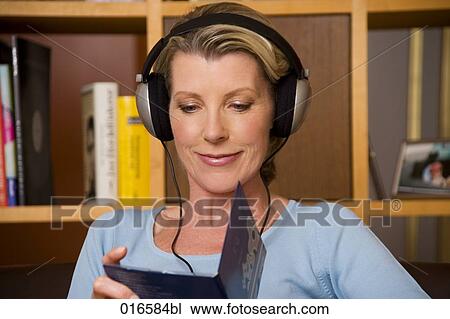 portrait of mature woman listening to music with headphones View Large Photo Image Stock Image - portrait of mature woman listening to music with headphones. Fotosearch