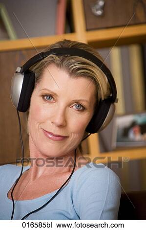 portrait of mature woman listening to music with headphones View Large Photo Image Stock Image - portrait of mature woman listening to music with headphones. Fotosearch
