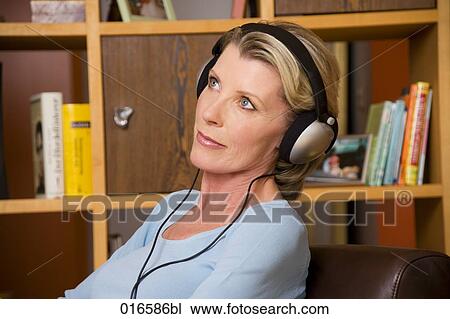 portrait of mature woman listening to music with headphones View Large Photo Image Stock Image - portrait of mature woman listening to music with headphones. Fotosearch