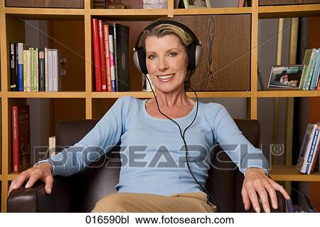portrait of mature woman listening to music with headphones View Large Photo Image Stock Image - portrait of mature woman listening to music with headphones. Fotosearch