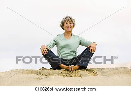 portrait of mature woman meditating on sandy beach View Large Photo Image Stock Image - portrait of mature woman meditating on sandy beach. Fotosearch