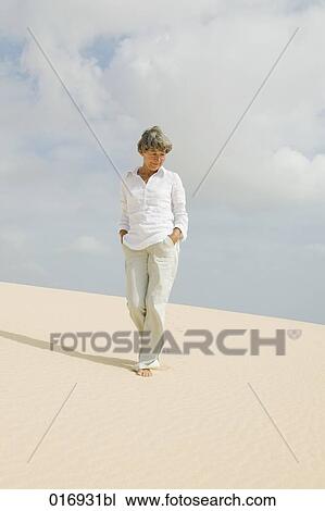 portrait of mature woman walking barefoot on sandy beach View Large Photo Image Stock Image - portrait of mature woman walking barefoot on sandy beach. Fotosearch