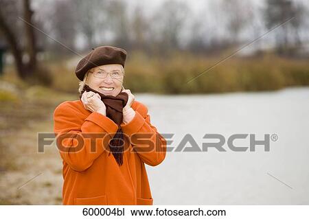 portrait of mature woman wearing brown beret standing at lake in park View Large Photo Image Stock Image - portrait of mature woman wearing brown beret standing at lake in park. Fotosearch