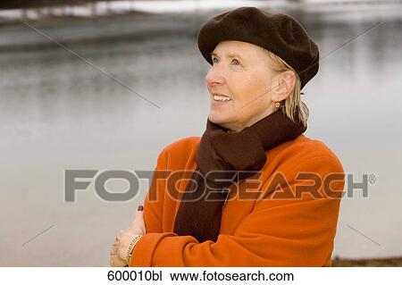 portrait of mature woman wearing brown beret standing at lake in park View Large Photo Image Stock Image - portrait of mature woman wearing brown beret standing at lake in park. Fotosearch